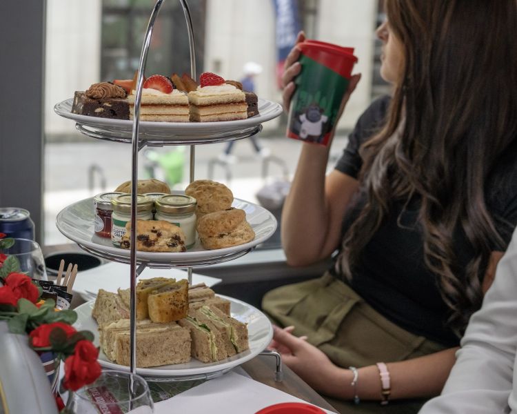 Couple enjoying a pg tips afternoon tea on a tour bus in london