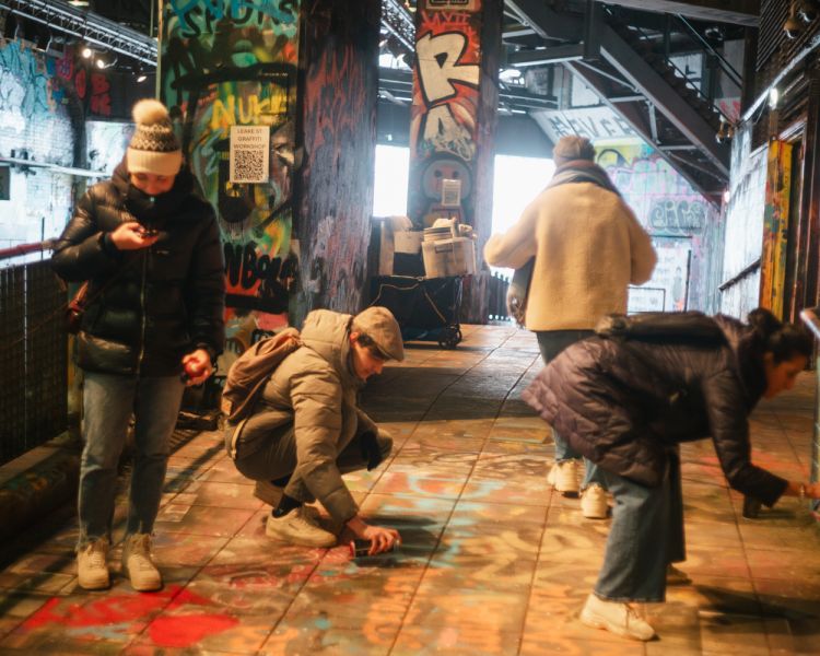 Tour group in graffiti tunnel in london