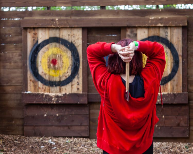 woman ready to throw axe at go ape axe throwing experience