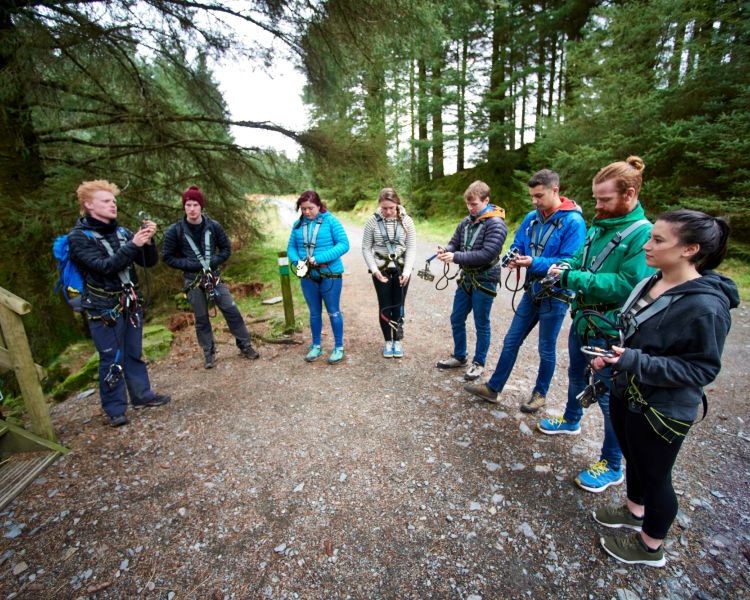 instructor talking to group on zip trekking adventure at go ape