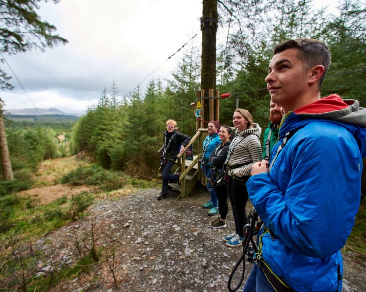 group waiting to go down zip line on a zip trekking adventure at go ape