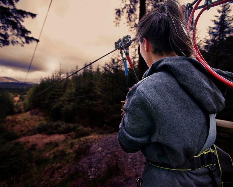 girl about to go down zip line at go ape zip trekking adventure