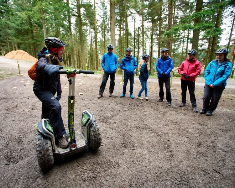 instructor talking to group on forest segway experience at go ape