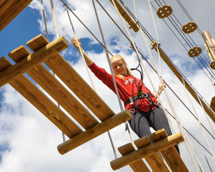 girl walking the go ape treetop challenge course
