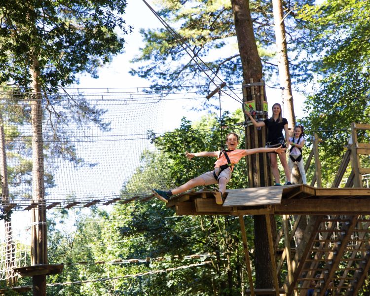 boy on zip wire on the treetop adventure course at go ape
