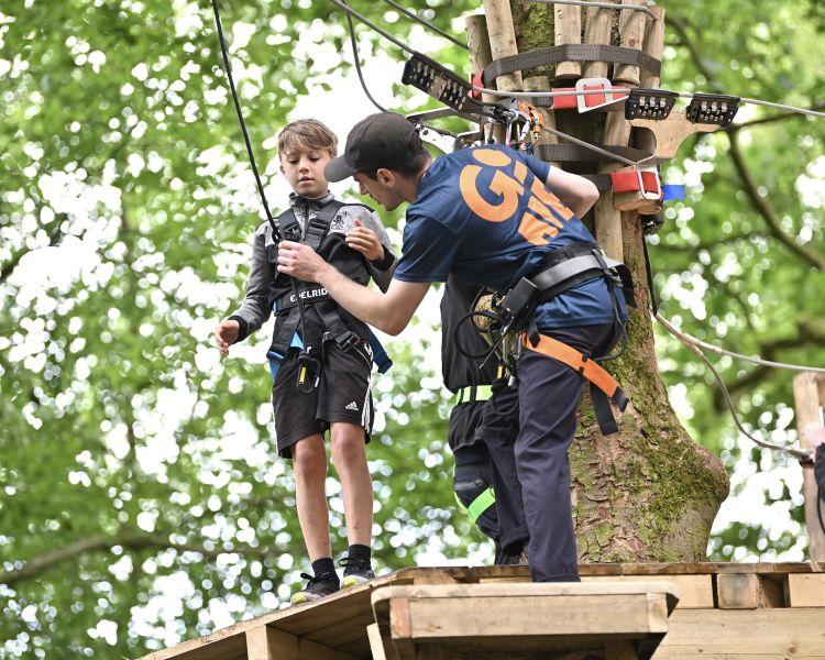 boy and instructor on treetop adventure plus course at go ape