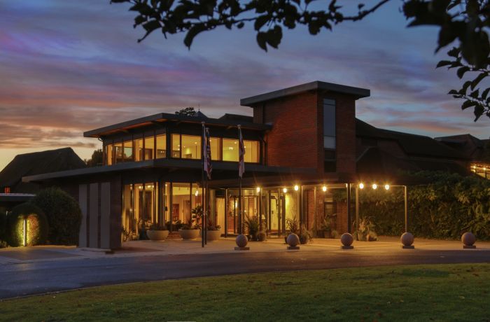 the exterior of q hotels norton park lit up at night