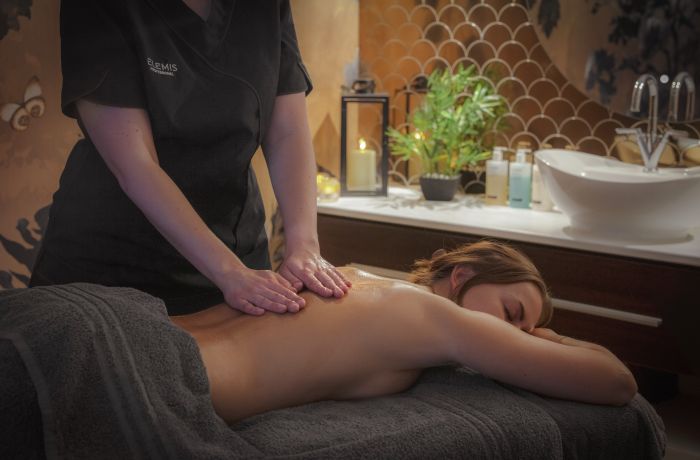 woman having massage treatment at q hotels dunston hall in norfolk
