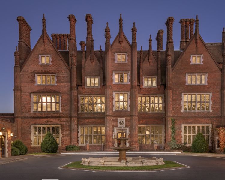 exterior of q hotels dunston hall in norfolk at night