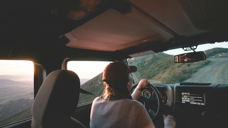 Woman driving 4x4 on country road