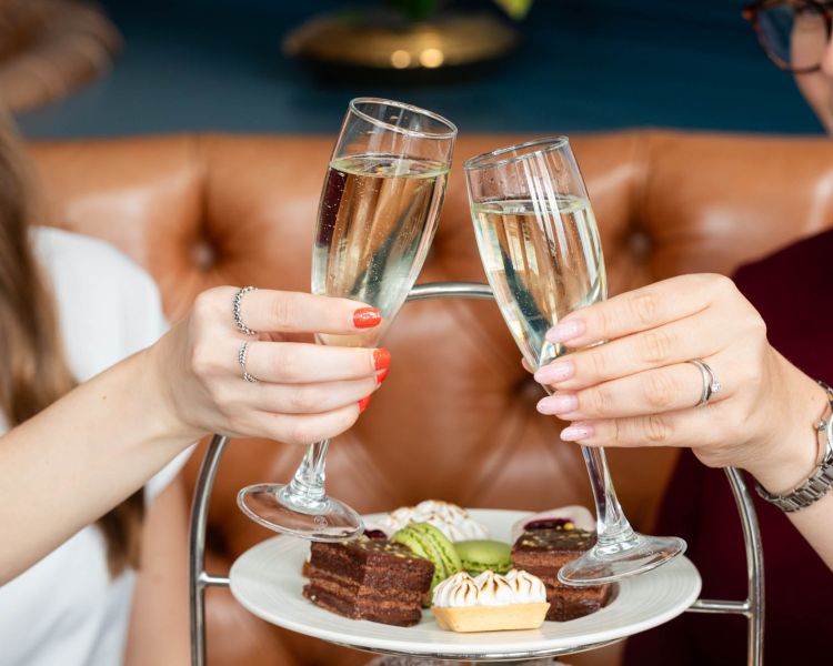 Women enjoying a champagne afternoon tea at doubletreeby hilton brighton metropole