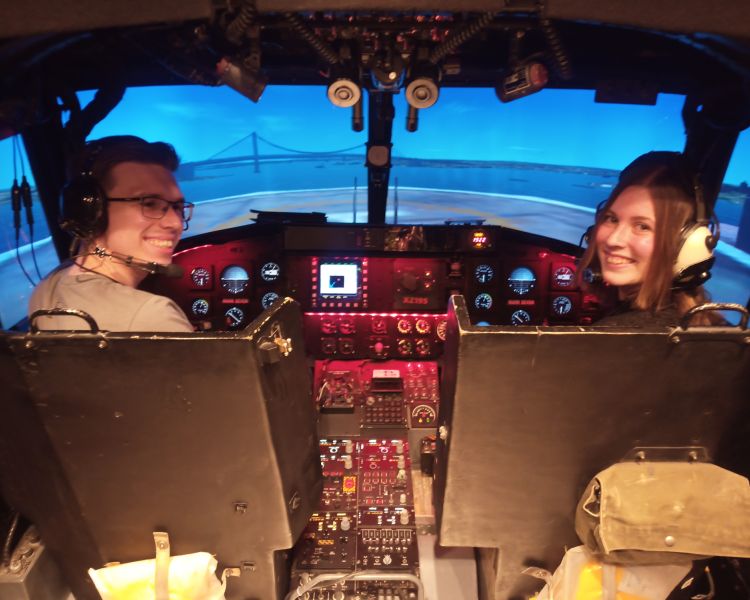 Man and woman in lynx helicopter flight simulator