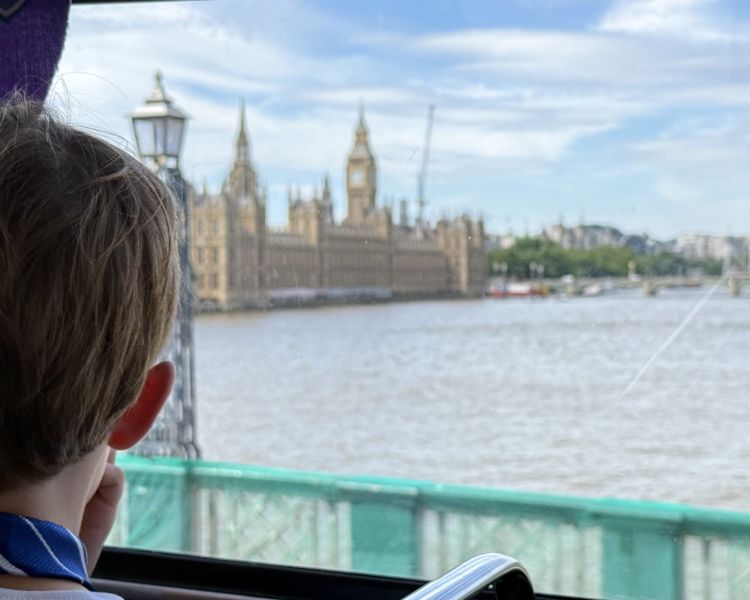Boy looking out window on harry potter london bus tour