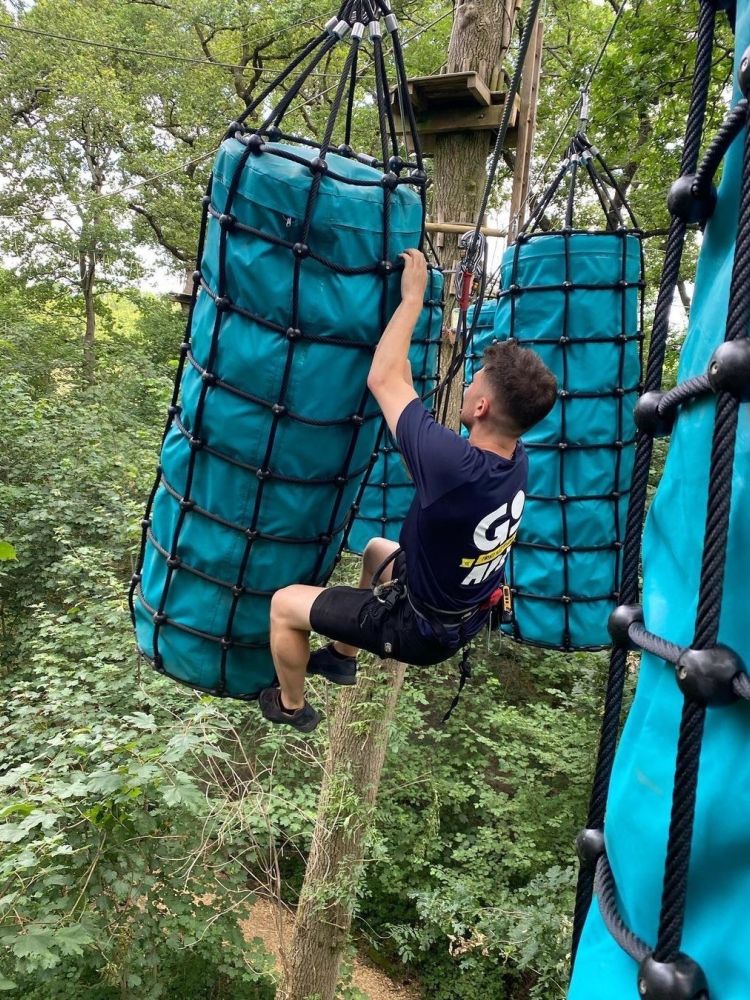Man on go ape challenge plus course high in the trees