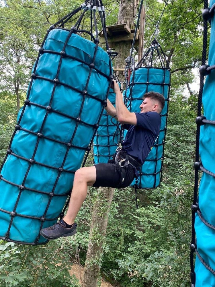 Man on the hanging bridge of the go ape challenge plus course