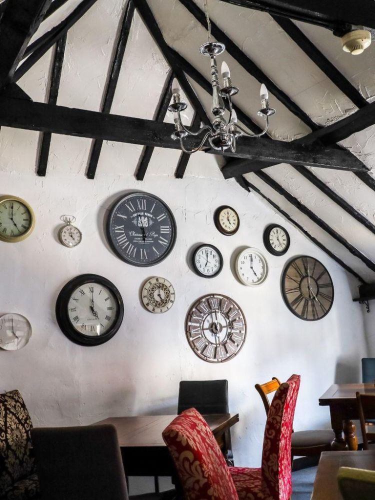 Tea room with wall full of clocks