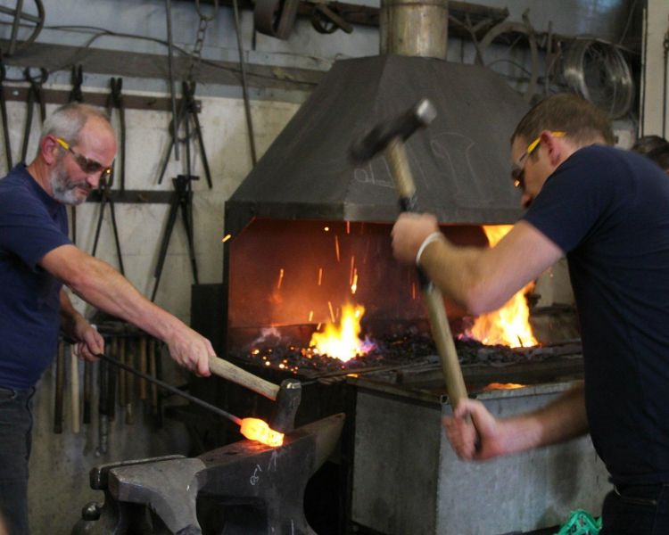 Man hitting hot metal to make an axe head
