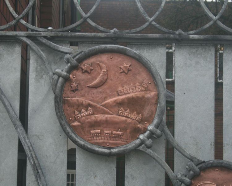 Copper repousse design on a gate