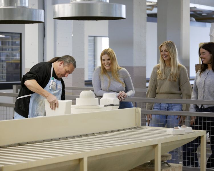 ladies watching worker on wedgwood factory tour