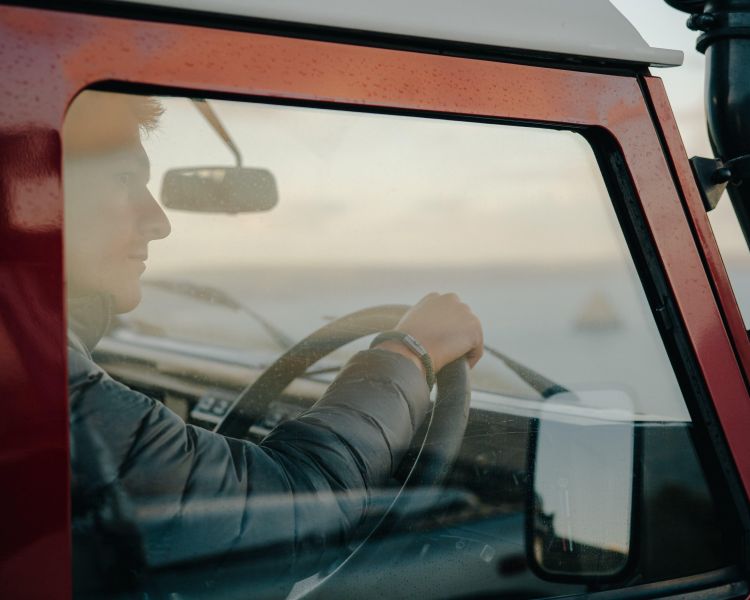 Man at wheel of land rover defender