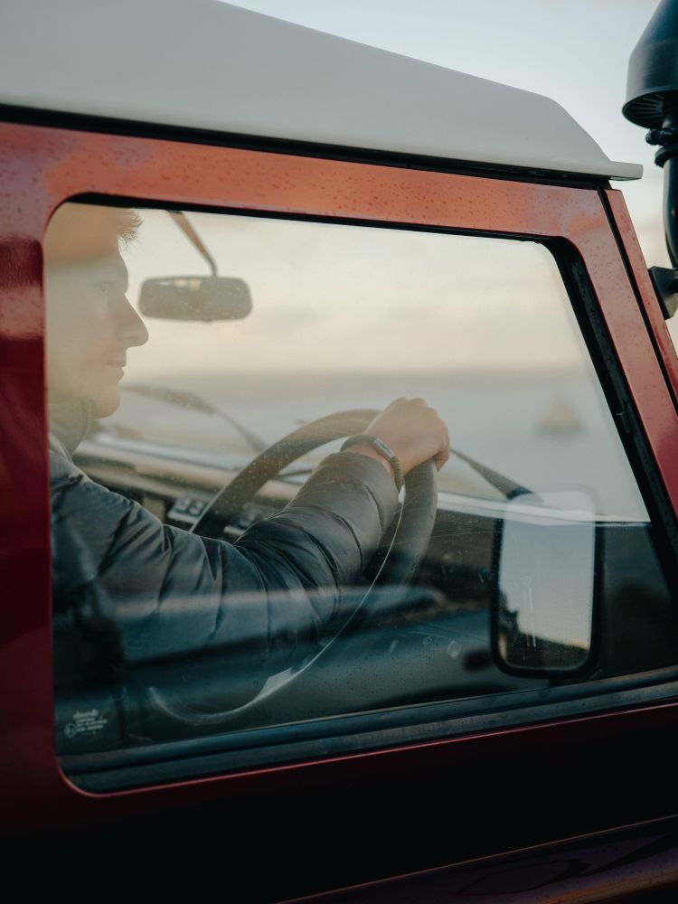 Man at wheel of land rover defender