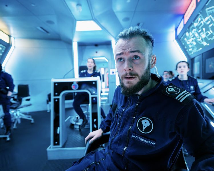 people on an immersive spaceship simulator experience in london
