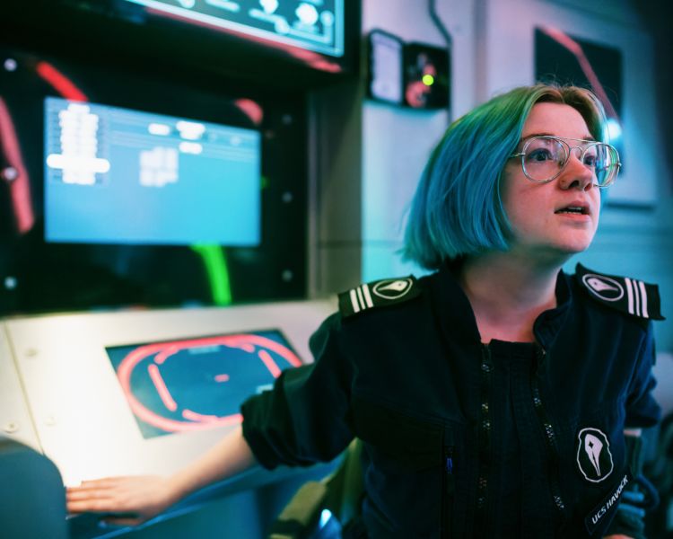 woman in drone management role on spaceship simulator experience in london