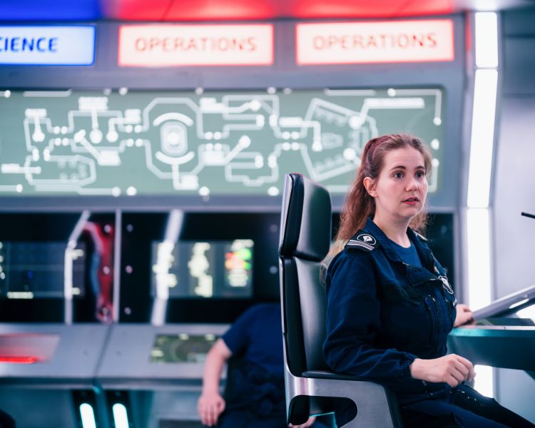 woman in the captain's role on immersive spaceship simulator experience in london