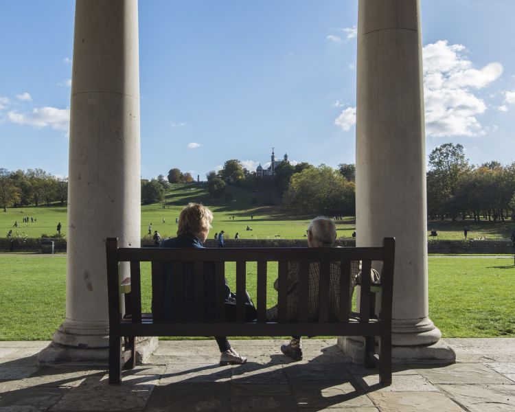Couple sitting on bench in greenwich park