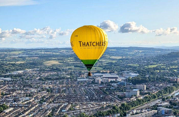 Hot air balloon flying over city of bristol