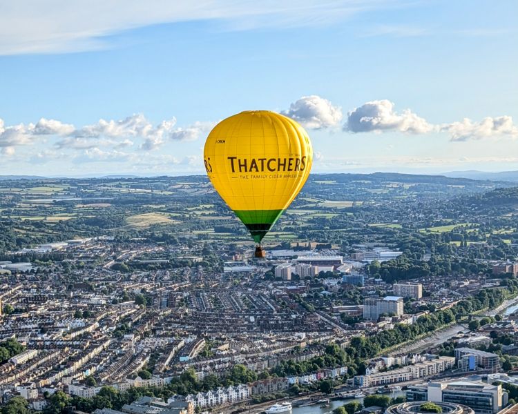 Hot air balloon flying over city of bristol