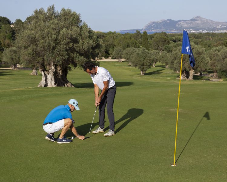 Man receiving golf tuition on a golf course