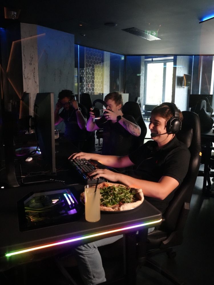 two men playing games on pc at gaming bar in london