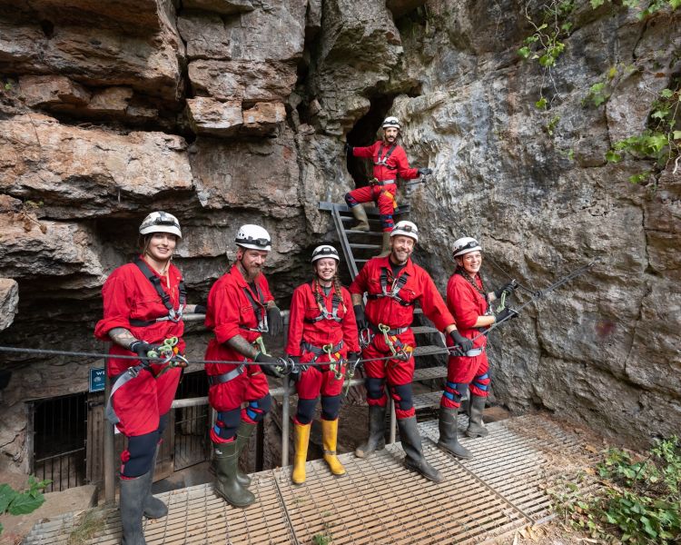 group standing outside entrance to wookey hole for caving experience
