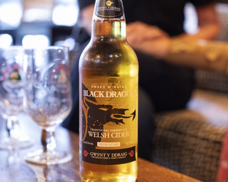 Bottle of black dragon welsh beer on table