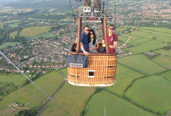 couple on a private hot air balloon ride with countryside views below