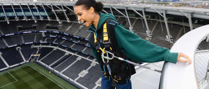 visitor looking out over the pitch on the tottenham hotspur skywalk experience in london