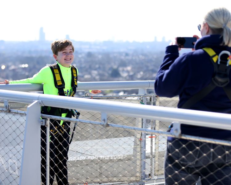 visitor having their photo taken on the tottenham hotspur skywalk experience in london