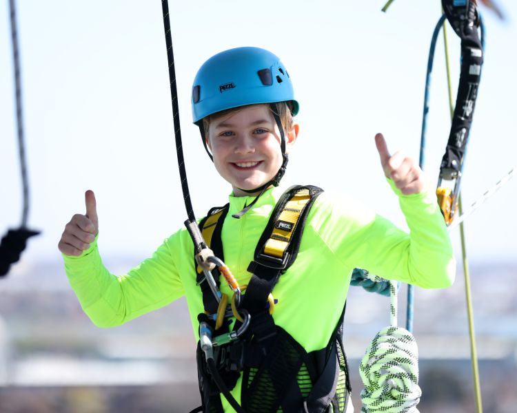 young boy in a harness on the tottenham hotspur skywalk experience in london