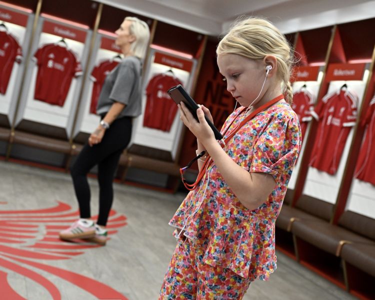 woman and girl in dressing room on liverpool fc stadium tour