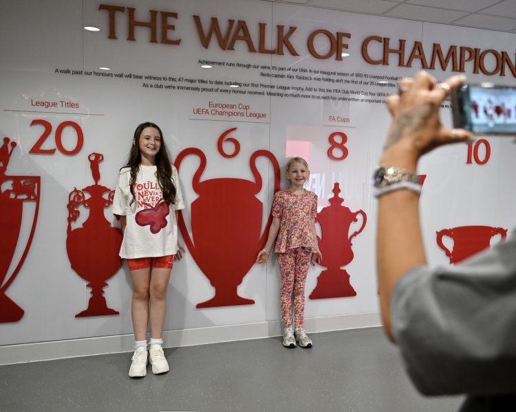 girls having photo taken against wall at liverpool fc
