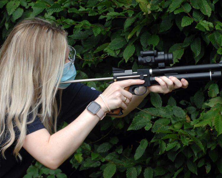 woman aiming an air rifle on an air rifle shooting experience with rapid airgun training