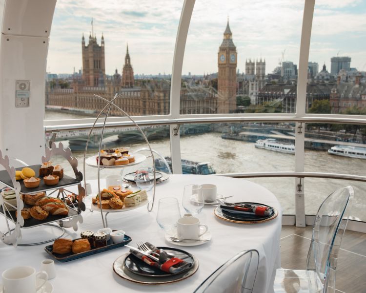 afternoon tea on table with view to big ben from the london eye