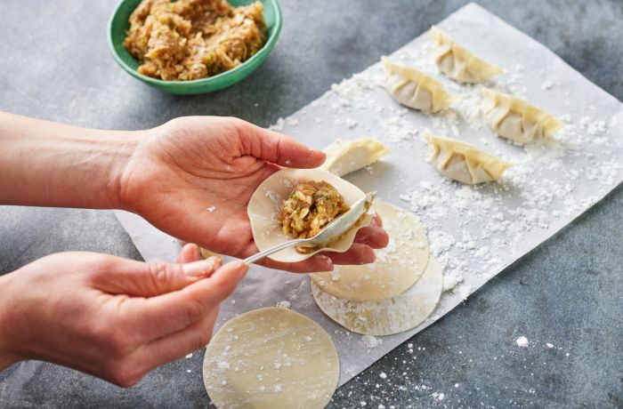 japanese gyoza being filled at jamie oliver cookery school class