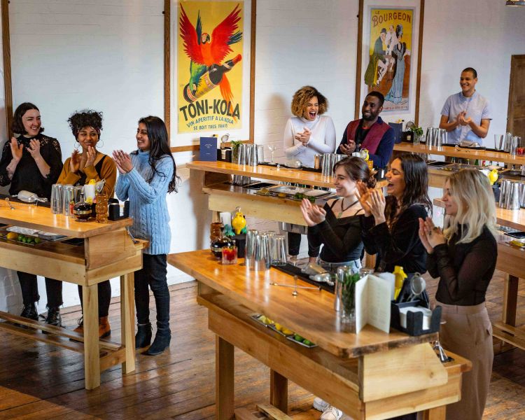people behind bar stations at cocktail class in london