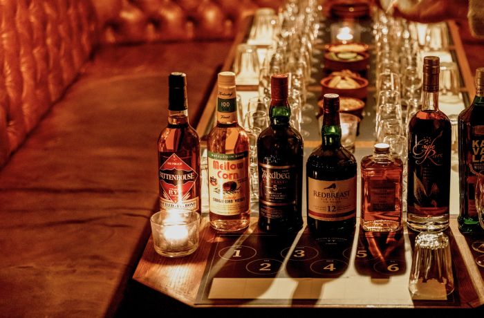 bottles of whisky lined up on table for a whisky tasting experience