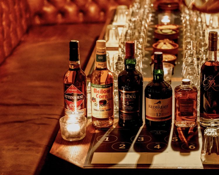 bottles of whisky lined up on table for a whisky tasting experience