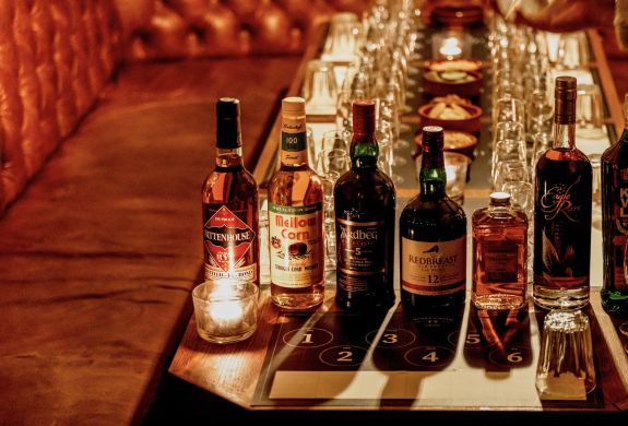 bottles of whisky lined up on table for a whisky tasting experience