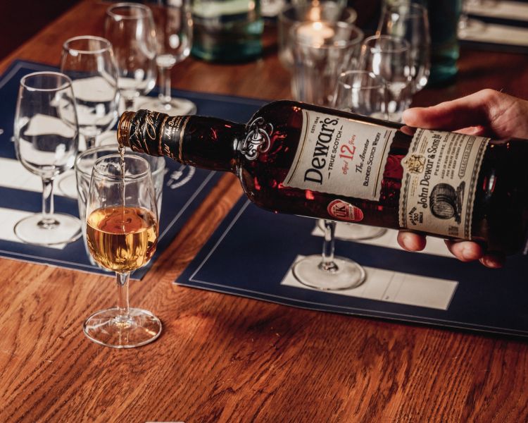 whisky being poured into a glass for a whisky tasting experience in london