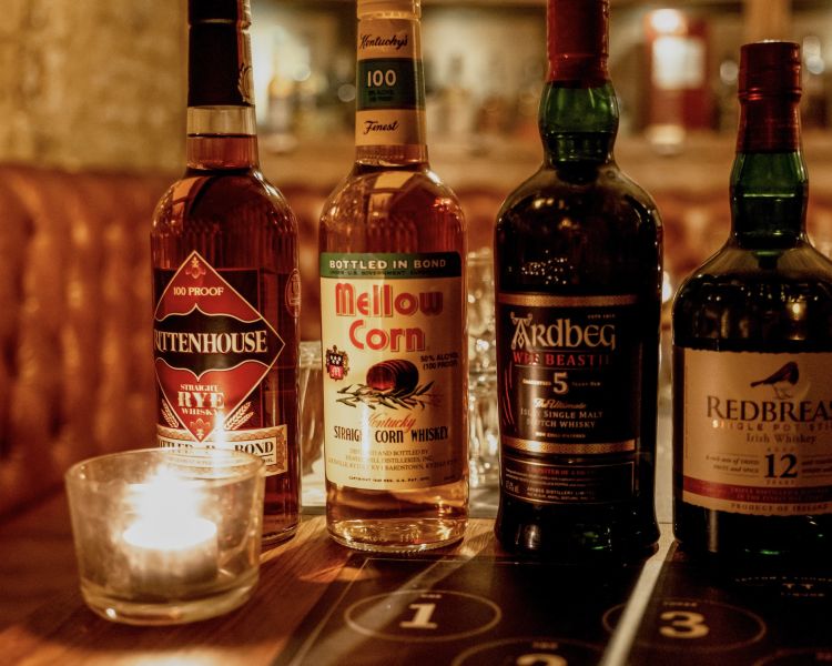 close up of bottles of whisky for a whisky tasting in london
